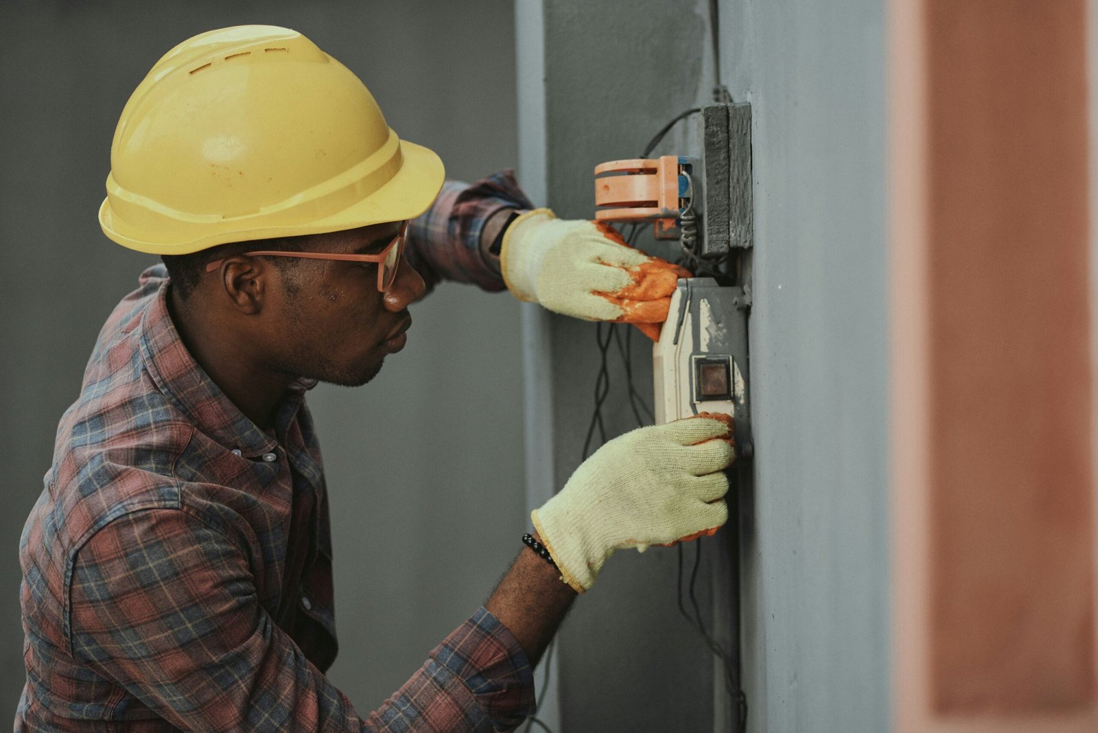 Electrician installing wiring on a home electrical panel in Houston