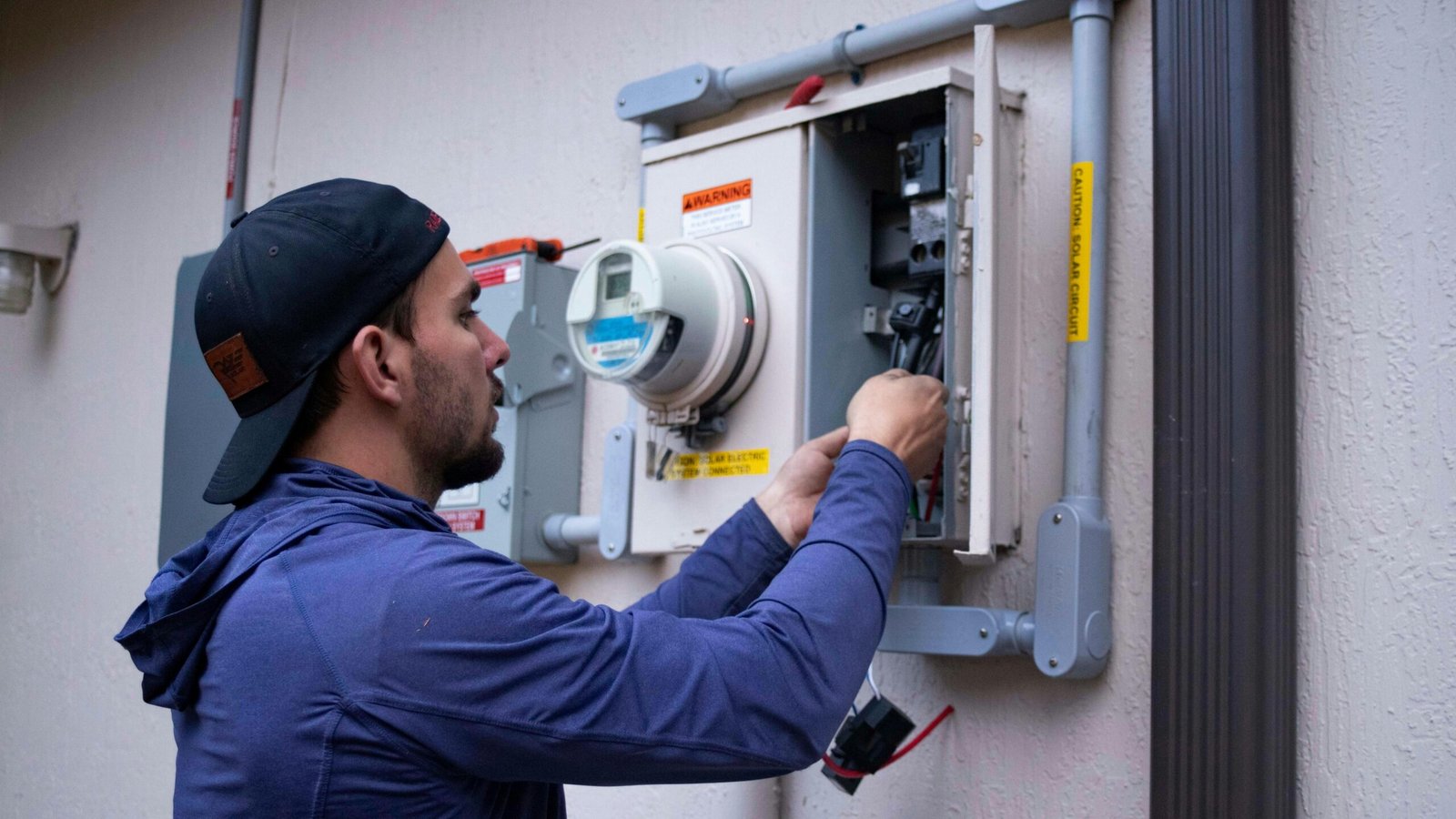 Technician servicing a home utility panel in Houston